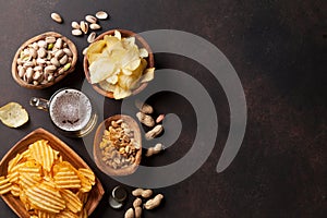 Lager beer and snacks on stone table