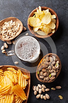 Lager beer and snacks on stone table