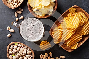 Lager beer and snacks on stone table