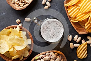 Lager beer and snacks on stone table