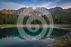 Lago di Carezza\'s emerald waters, misty forests, and Latemar views photo