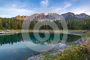 Lago di Carezza\'s emerald waters, misty forests, and Latemar views form an unrivaled Alpine charm photo