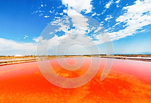 Red salt lake with cloudy sky reflection photo