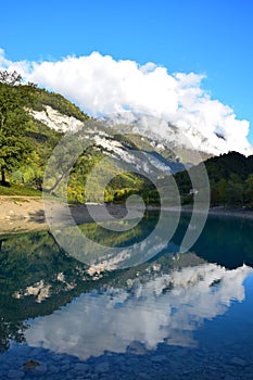 Lago di Tenno with its clear turquoise water in the morning light. Trentino, Italy