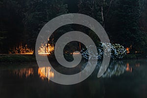 Lago Negro lake with fog, lights and reflection at night photo