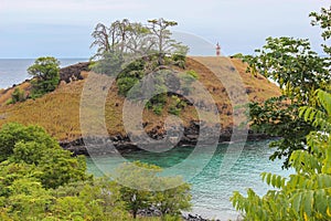 Lagoa Azul Blue Lake a beautiful beach with baobab and a lighthouse up the cliff in Sao Tome and Principe - Africa