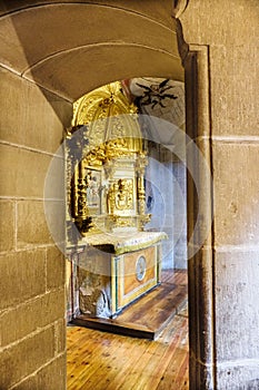 Laguardia, Alava, Spain. March 30, 2018: View of a side chapel of the Church of San Juan with a golden altarpiece and an entrance