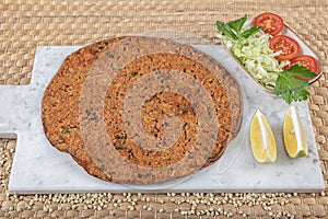 Lahmacun from buckwheat flour. Turkish dishes: lahmacun, turkish pizzas, lemon, parsley. Healthy eating, dieting, slimming and