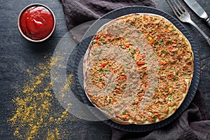 Lahmacun traditional turkish delicious pizza with minced beef or lamb meat, paprika, tomatoes, cumin spice