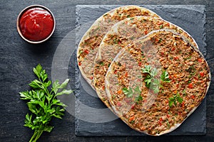 Lahmacun traditional turkish pizza with minced beef or lamb meat, paprika tomatoes, parsley baked spicy food