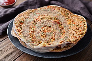 Lahmacun turkish delicious pizza with minced beef or lamb meat, paprika, tomatoes