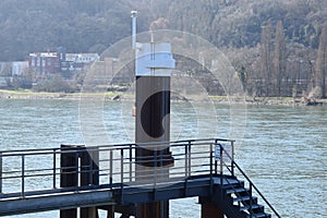 Lahnstein, Germany - 03 24 2021: Rhine harbor with a bridge and stairs towards ships