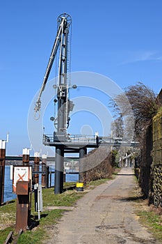 Lahnstein, Germany - 03 24 2021: Rhine harbor crane at the publis bike and pedestrian route along the river