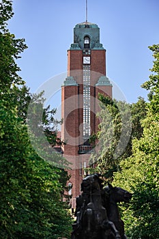 View of tower on Town Hall through trees. Clock on the tower