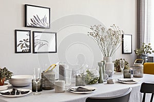 Laid table with champagne glasses and flowers in a modern dining room interior