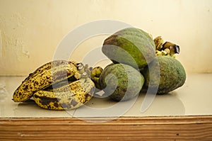 Lakatan Bananas and Avocado Pears On White Surface