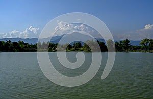 Lake across the mountains and blue sky with clouds. Scenic landscape. Italy, Torino, Turin