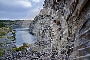 Lake in an ancient quarry with various types of rocks