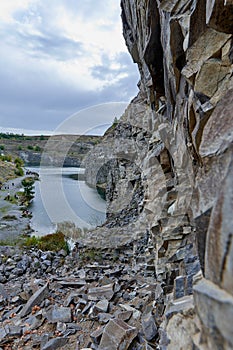 Lake in an ancient quarry with various types of rocks