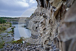 Lake in an ancient quarry with various types of rocks