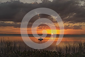 Lake Apopka Florida Summer Sunset with small boat