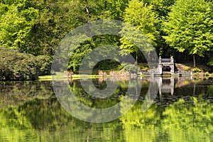 Lake with artificial waterfall in royal park Kroondomein