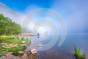 Lake awakening morning fog photo