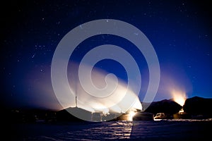 Lake Baikal. Yurts fishermen on the ice under the starry sky.