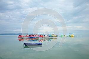 Lake Balaton with pedalos and a boat in the front