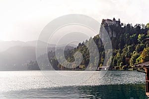 Lake Bled in autumn, fog forest landscape with castle on a hill, Slovenia, Slovenija