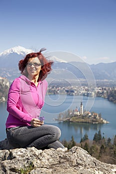 Lake Bled and woman picking flowers