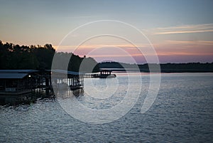 Lake and boat dock at sunrise