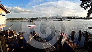 Lake boatman paddle his row boat across the lake