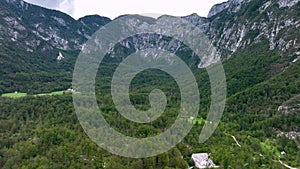 LAKE BOHINJSKO, SLOVENIA - APRIL, 2023: Aerial drone footage. Mauntain landscape near lake from the air on sunny day