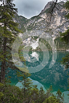 Lake Braies also known as Lago di Braies. The lake is surrounded by the mountains which are reflected in the water photo