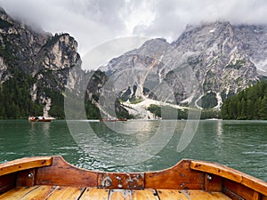 Lake Braies, Italy. POV oarsman the traditional boats made of wood. Amazing view of the famous lake Braies. Alpine lake