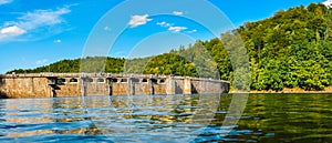 Lake Bystrzyckie located in a mountain valley, a dam on the Bystrzyca River, view from the lake shore on a sunny summer day