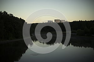 Lake in city. Pond in evening. Natural object in park. Forest reflection in water