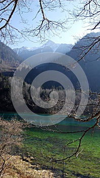 Lake with clear crisp water surrounded with Mountaineous Scenery photo