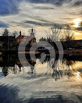 Lake in cloudy day with church