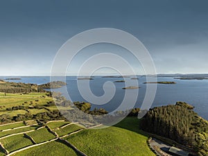 Lake Corrib, county Galway Ireland, Sunny day with clean blue sky and green fields separated by stone fences, islands in the lake