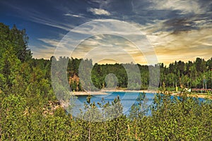 A lake with crystal clear water. The concept of rest by the lake