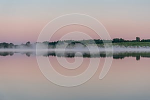 Lake dawn fog trees reflection