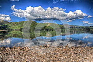 Lake District England beautiful calm sunny summer day at derwent water with reflections and clouds HDR