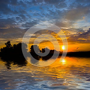 lake with dramatic sunset reflected in a water