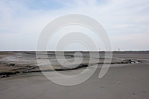 Lake of dry mud formed from a mud volcano eruption in Sidoarjo, East Java, Indonesia with clouds in blue sky