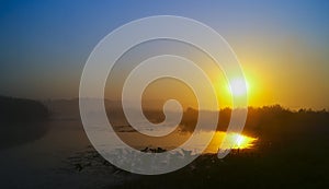 Lake with ducks which reflects the sunset