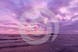 A lake at dusk, with beautiful, warm tones in the sky, clouds an