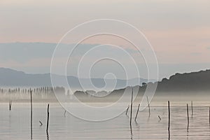 A lake at dusk, with beautiful, warm tones in the sky and water