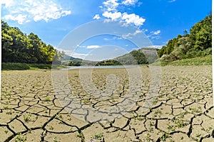 Lake eleshnitsa with cracked mud pattern in foreground